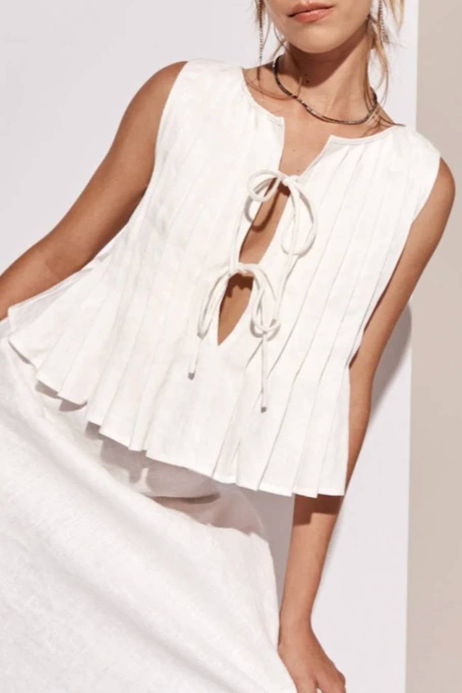 Pleated bow tie front sleeveless top